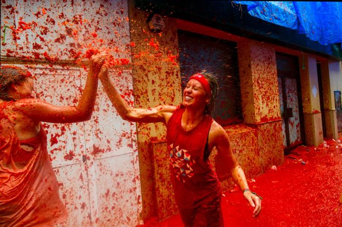 Participants relishing the tomato pulp vibe of La Tomatina