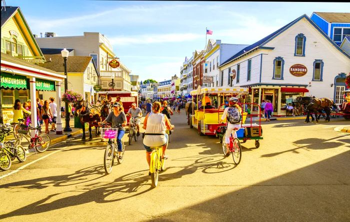 Visitors stroll and bike along a street