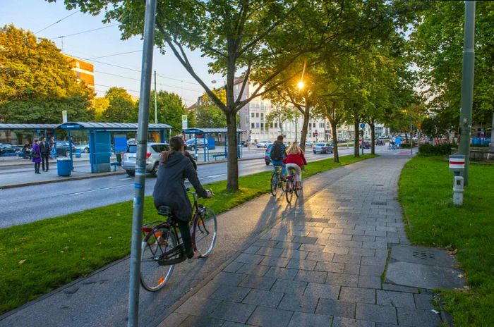 Cyclists riding past trams in the afternoon in Munich