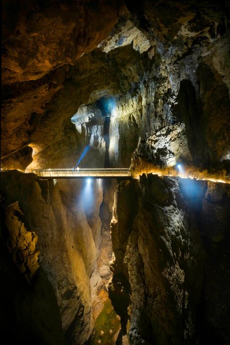 A bridge spans the Reka River within the Škocjan Caves, which flows underground for an impressive 21 miles.