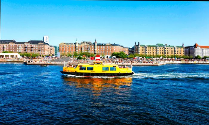 A yellow ‘harbor bus’ gliding through the waters of Copenhagen, Denmark, Europe