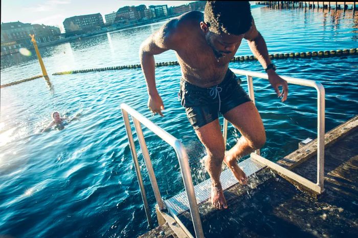 A man emerges from the water after taking a swim in Copenhagen's harbor, Denmark, Europe