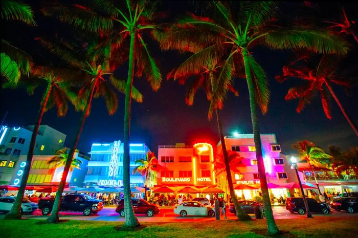 Cars cruising along Ocean Drive at night, Miami Beach, Florida, USA