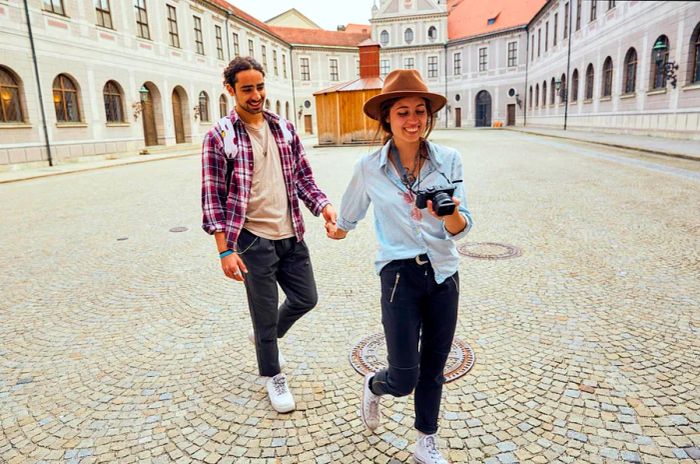 A couple strolling hand in hand through the streets of Munich