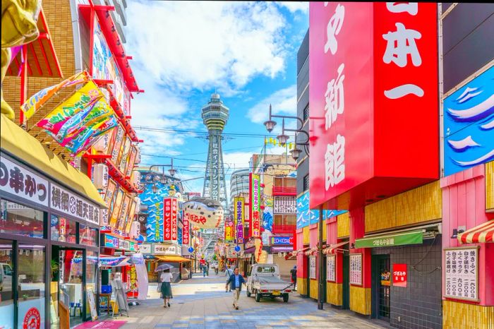 An Osaka street scene featuring the Tsūtenkaku Tower in the background