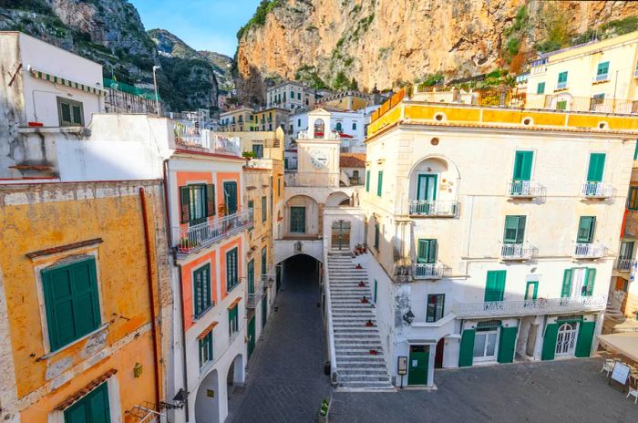 A quaint white church nestled among the narrow streets of a small town.