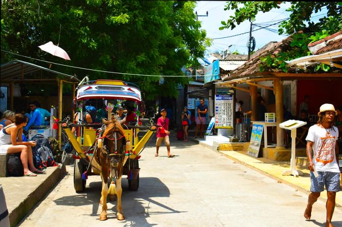 people waiting for a horse-drawn cart on the Gili Islands, Indonesia