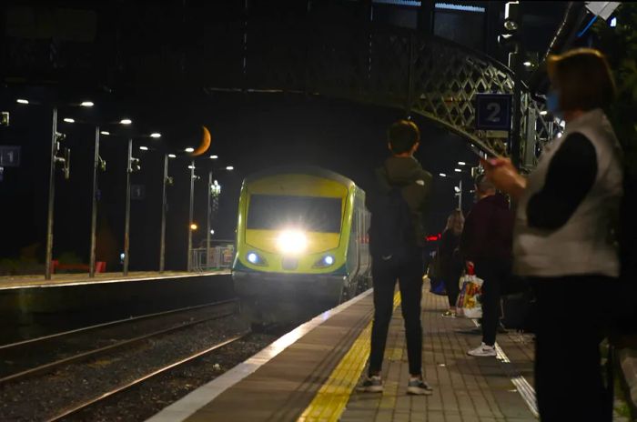 An evening scene on a bustling train platform