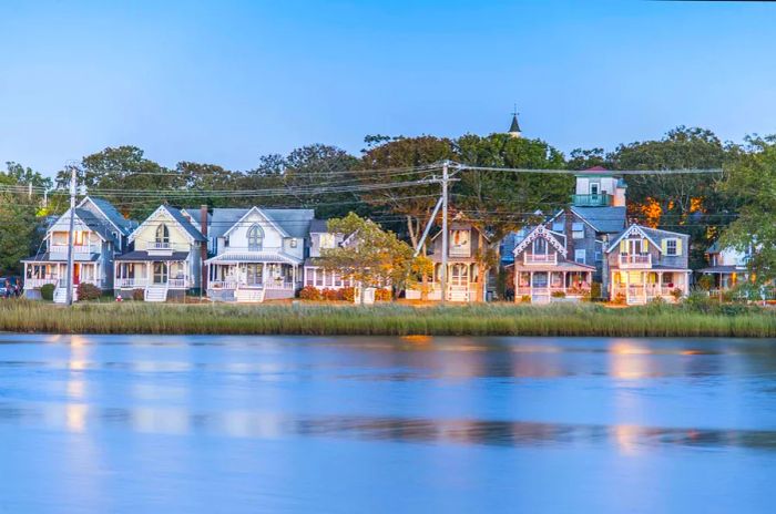 A line of large, pastel-colored wooden houses overlooks the waterfront