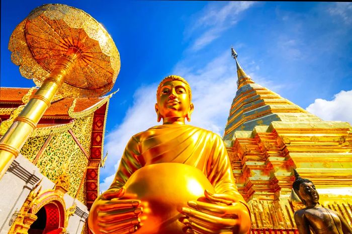 A magnificent gold Buddha statue nestled within a temple complex