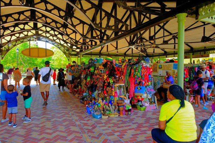 Visitors and vendors at an outdoor crafts market in Falmouth, Jamaica