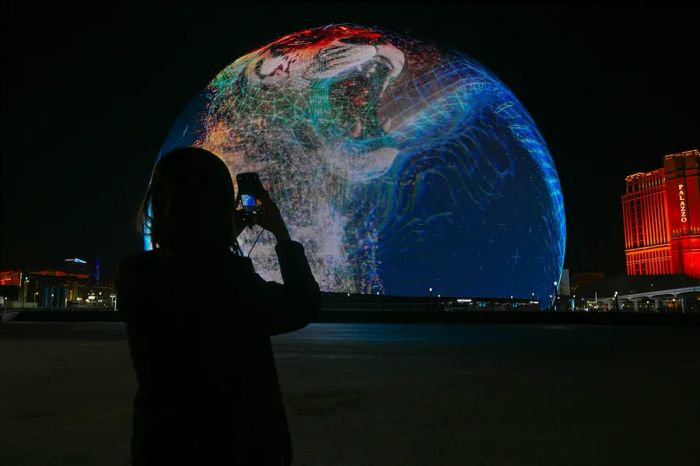 A visitor captures a photo of the striking Sphere venue in Las Vegas