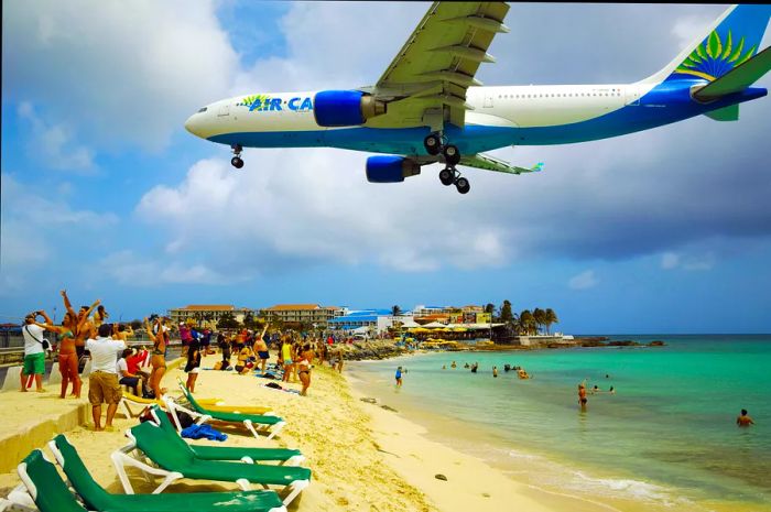 A plane soaring low above the beach in Sint Maarten