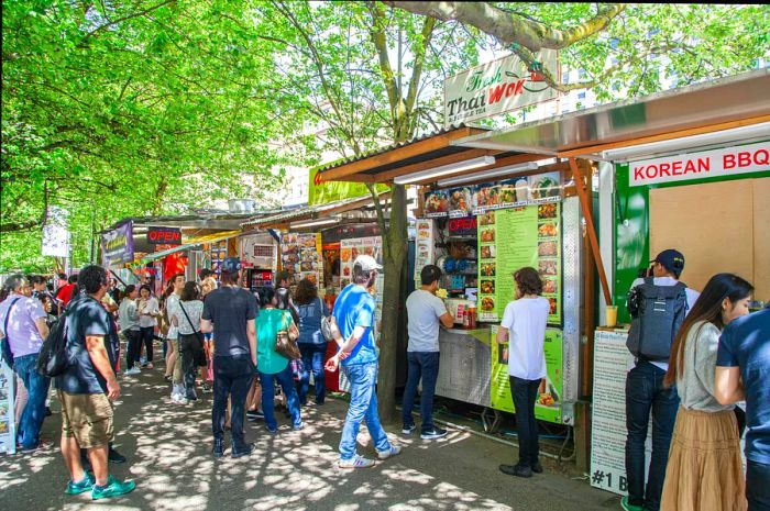 Lines of people eagerly awaiting their turn at street food carts