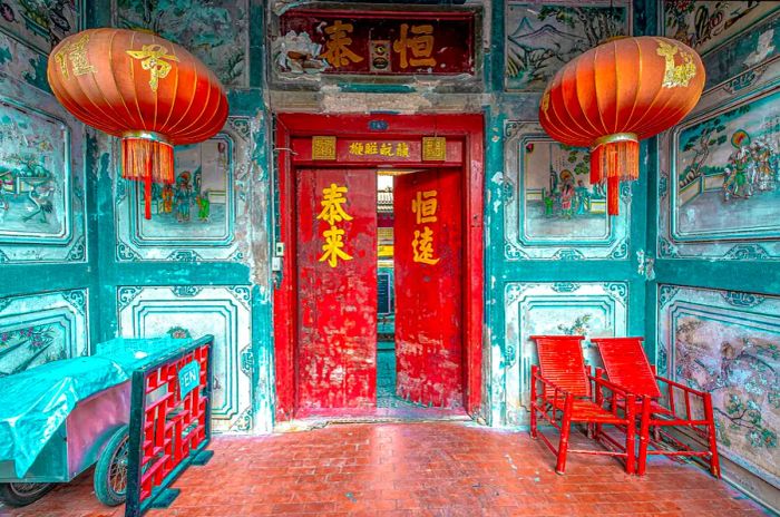 A Chinese-style temple entrance adorned with red lanterns on either side