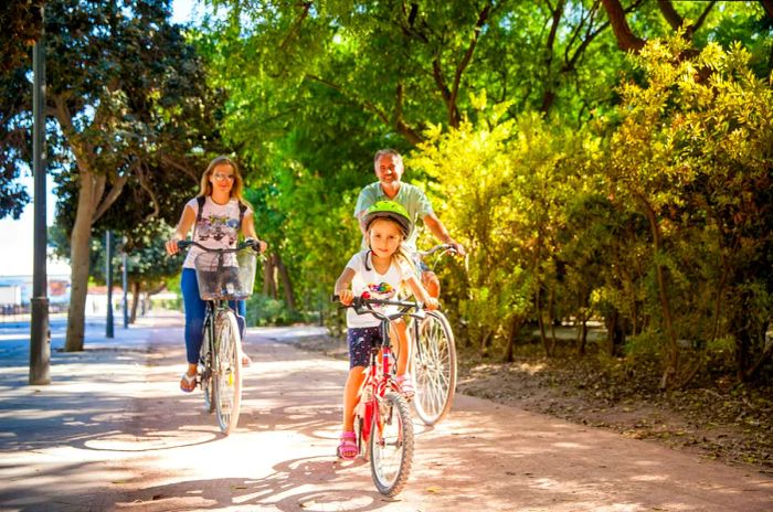 Father Riding a Bike with His Two Daughters in Valencia