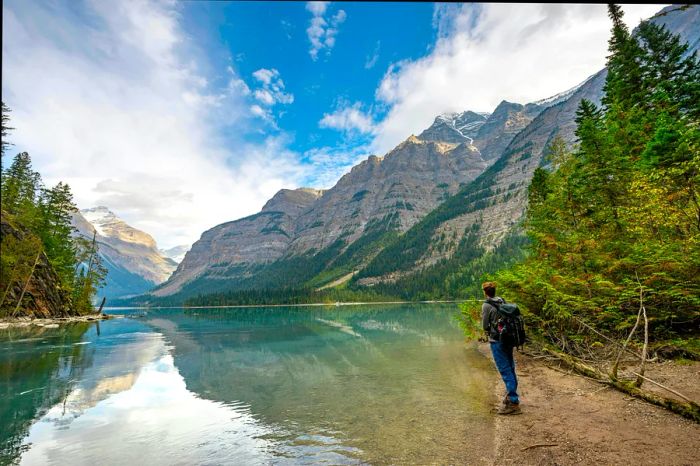 Hikers enjoy the picturesque shores of Kinney Lake in Mount Robson Provincial Park, British Columbia, Canada.