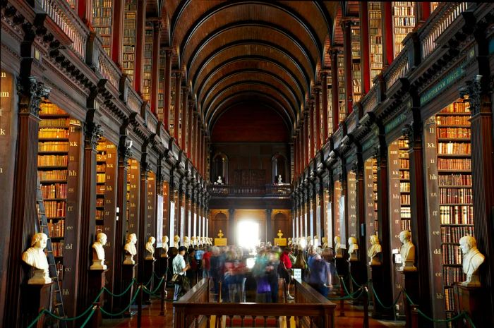 A dimly lit university room filled with books.