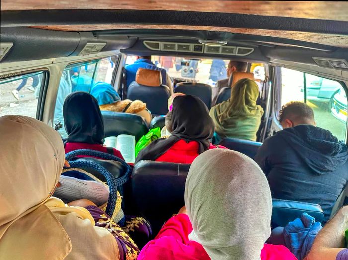 Inside a microbus with passengers tightly packed in their seats