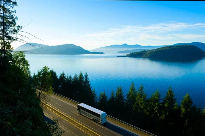 An aerial view of a bus traveling along the Sea to Sky Highway (Hwy 99) from Vancouver to Whistler, British Columbia, Canada