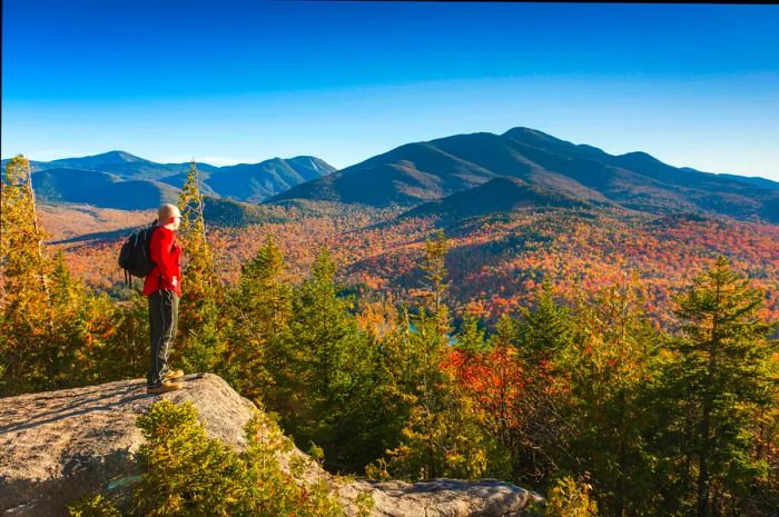 A hiker enjoying autumn in the Adirondack Mountains, New York State, USA