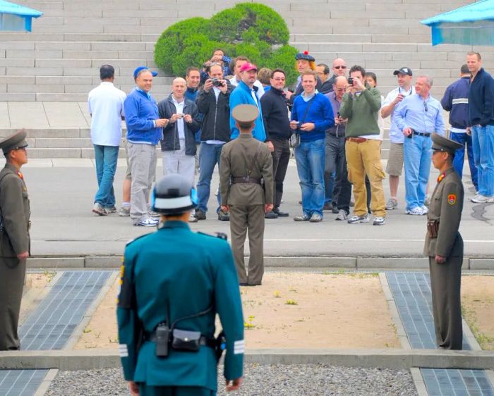 Foreign tourists visiting North Korea capture images of South Korea on April 30, 2008, while standing on the North Korean side of Panmunjom, the border village that has divided the two Koreas since the Korean War.