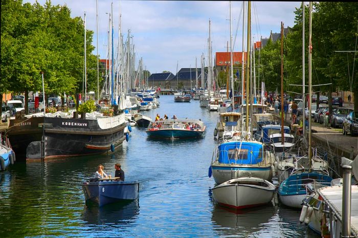 Boats glide along the canals in Copenhagen, Denmark