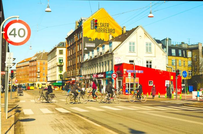 Cyclists navigate the vibrant streets of a trendy neighborhood filled with independent shops and stunning street art murals.