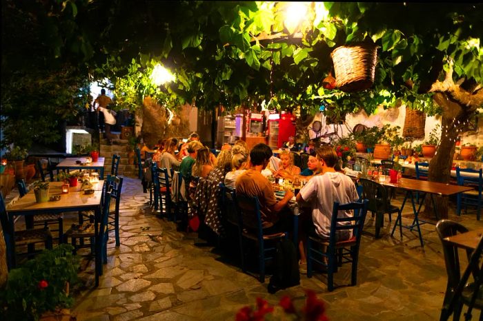 A group of friends enjoying al fresco dining at a taverna in Crete