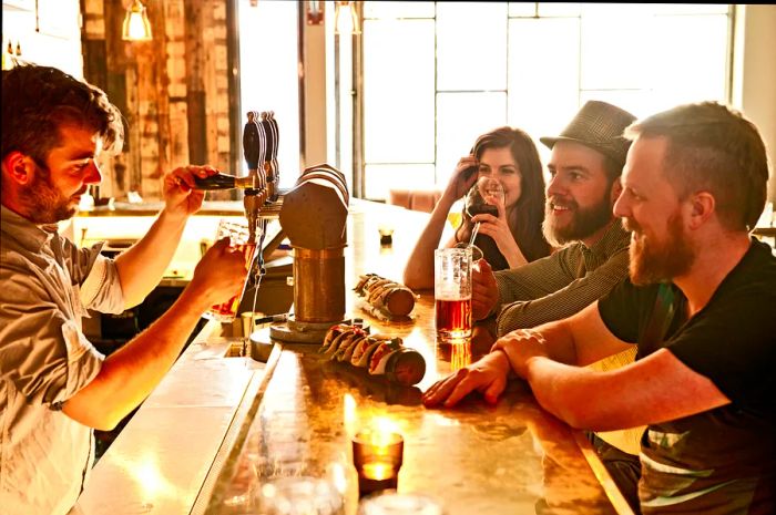 Friends enjoying beers at a trendy bar in Reykjavik