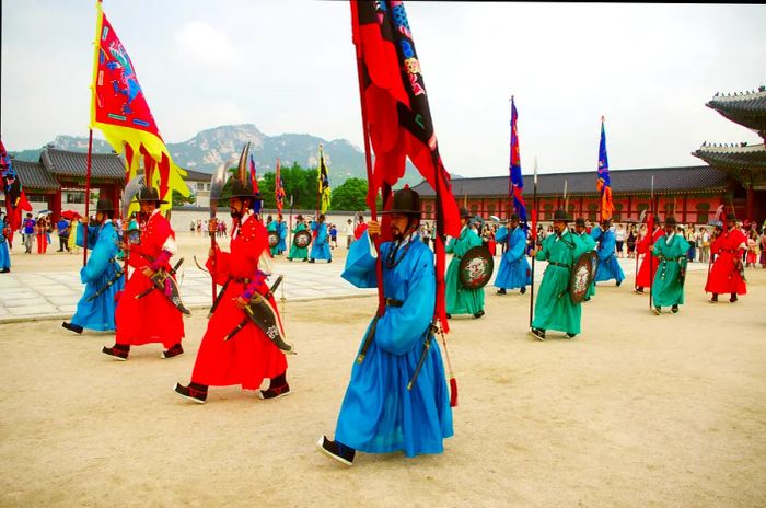 Soldiers dressed in traditional uniforms participate in the ceremonial changing of the guard