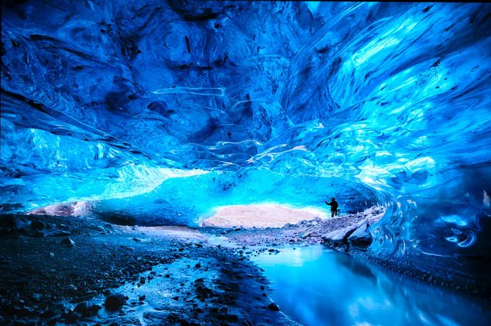 Inside the stunning blue glacial ice caves of Breiðamerkurjökull, part of the Vatnajökull glacier, Iceland