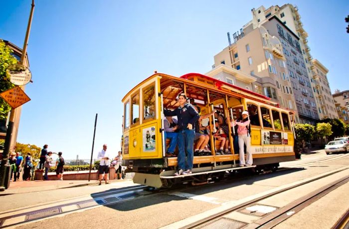 People enjoying a thrilling ride on a cable car racing down a hill.