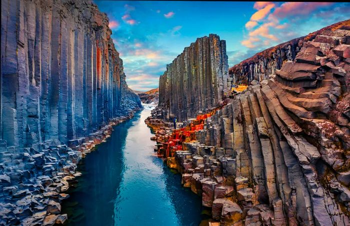 A river flows through a canyon with towering cliffs