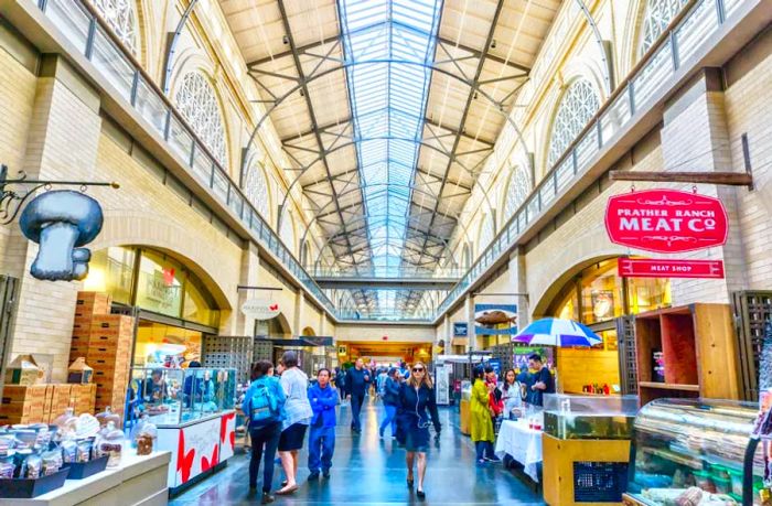 Shoppers exploring the food marketplace at the historic Ferry Building along Embarcadero in San Francisco, California, USA.