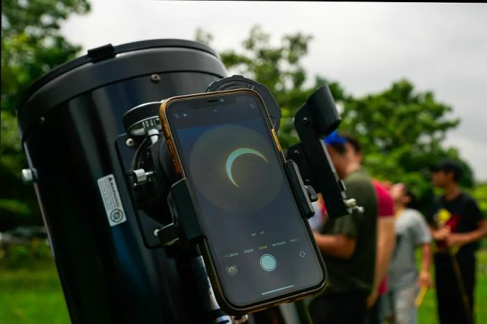 The solar eclipse viewed through a mobile phone attached to a telescope