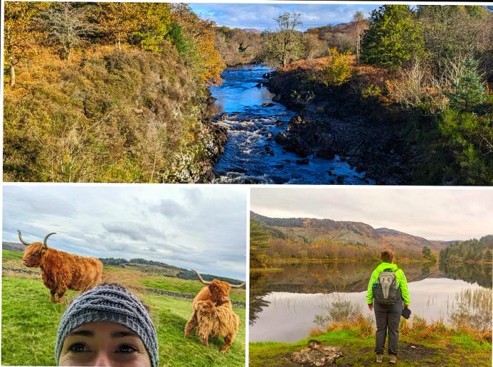 Amy, dressed in her high-visibility hiking gear, poses with alpacas by the water on a crisp autumn day in Dumfries and Galloway