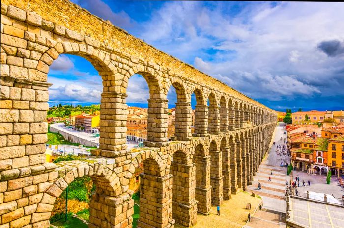 Tall sandstone aqueducts gracing a city square