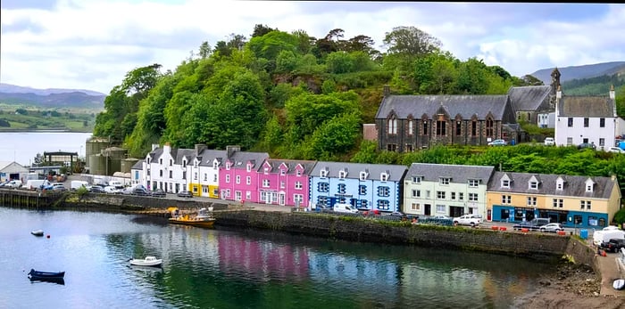 A picturesque view overlooking the vibrant village of Portree, the capital of the Isle of Skye, on a lovely spring day.