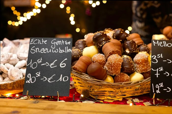 Enjoy 'Gentse sneeuwballen,' traditional Belgian sweets found at the Christmas market in the heart of Ghent, Flanders.