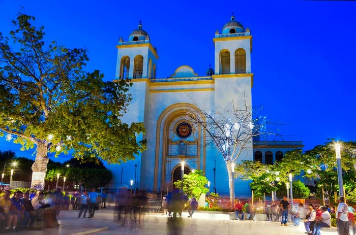 People strolling by San Salvador Cathedral in Plaza Barrios during the evening