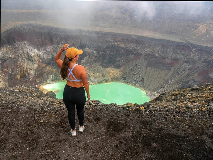 A woman gazes into the crater lake of Santa Ana Volcano, El Salvador