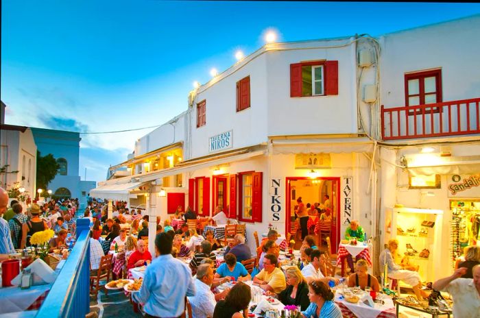 The vibrant dining atmosphere at Taverna Nikos in Mykonos