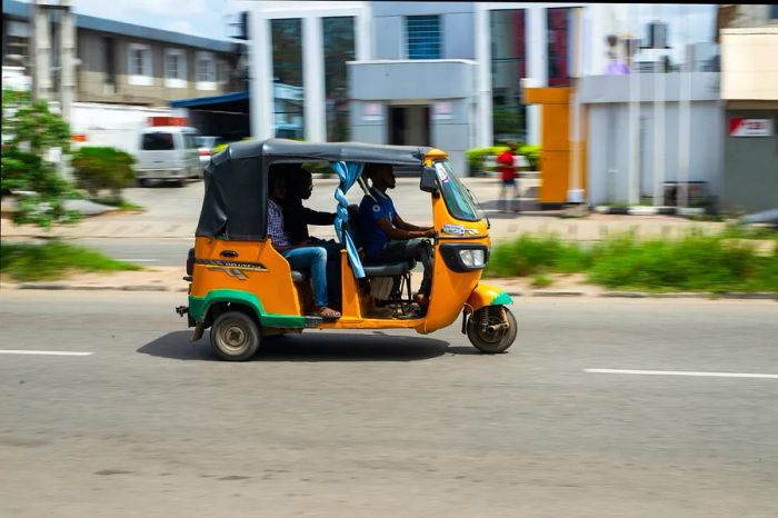 A keke (three-wheeled taxi) navigating the streets of Lagos, Nigeria