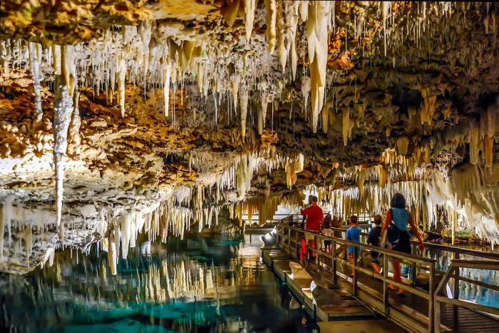 Visitors strolling beneath the impressive stalactites in Bermuda's Crystal Cave