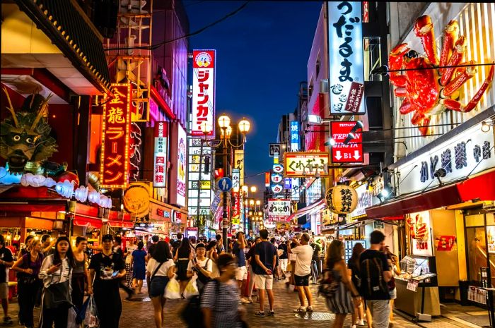 Crowds bustling in the Dotonbori shopping district, Osaka, Japan