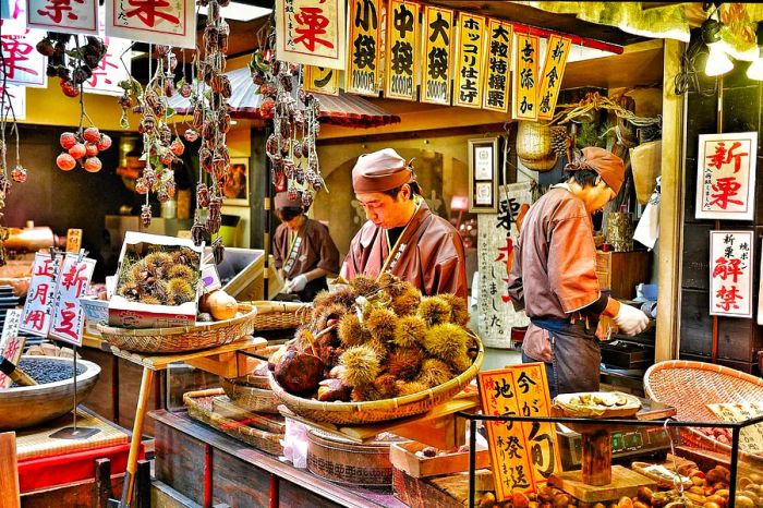 Vendors preparing chestnuts for sale at a market