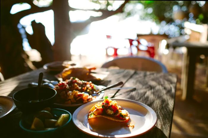 A close-up of traditional tacos served at a beachfront restaurant in Cancún.