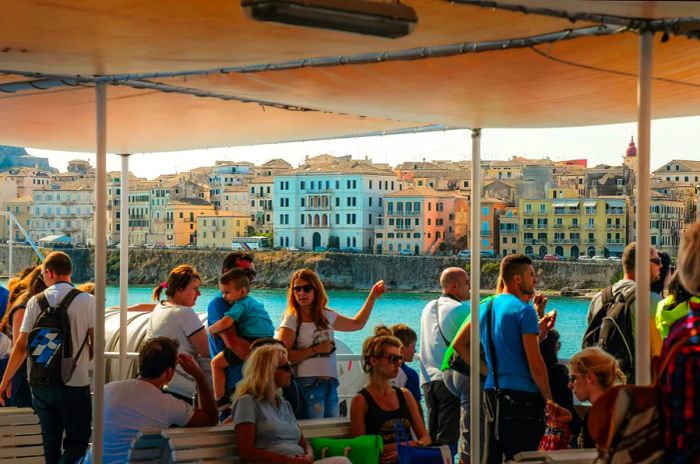 Tourists arriving in Corfu, Greece, aboard a ferry boat.