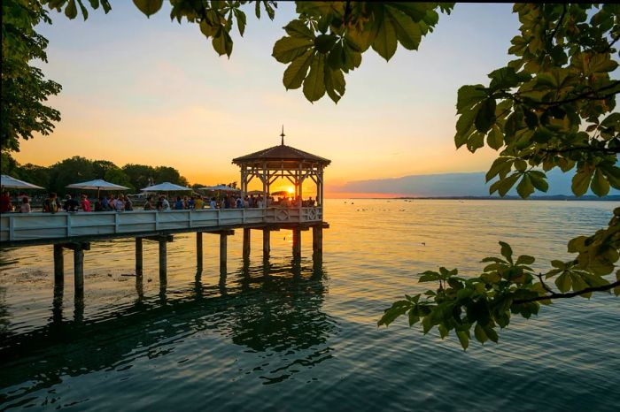 Pavilion with a bar overlooking Lake Constance at sunset.